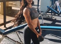 Mariah Stock showcasing her ripped arms at the outdoor gym