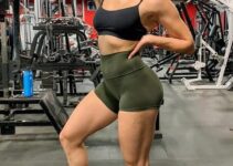 Annabel DaSilva flexing her biceps in the gym