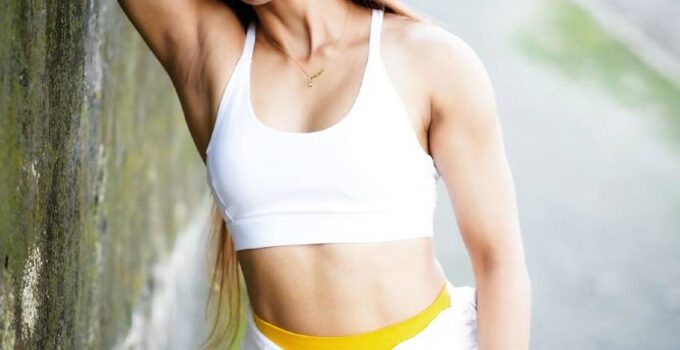 Vaishali Bhoir leaning against a wall wearing a fitness outfit, looking lean and toned