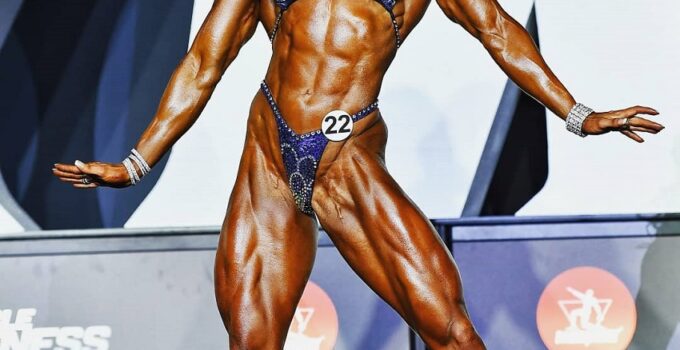 Autumn Swansen posing on the olympia stage looking aesthetic and ripped