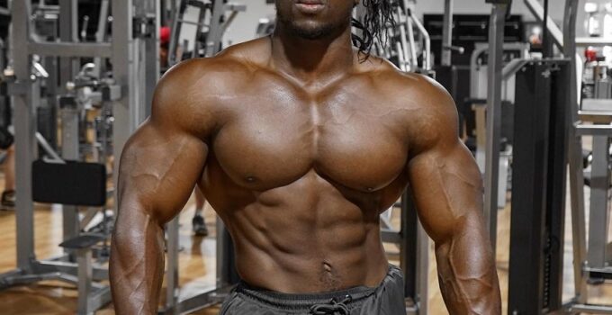 Kwame Duah posing shirtless in the gym