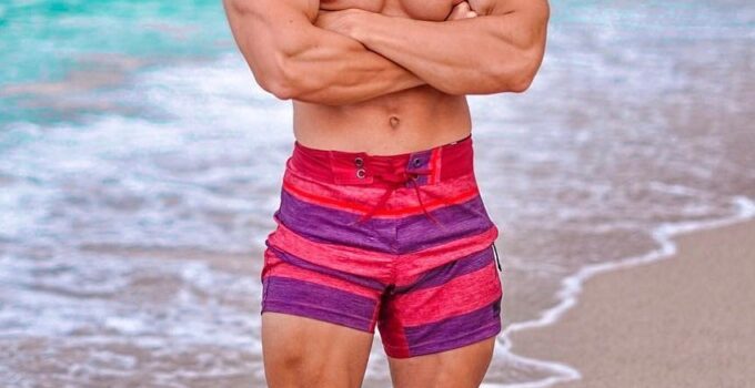 Radoslav Raychev standing shirtless on the beach looking strong and ripped