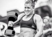 Alexis Johnson lifting a heavy dumbbell during a CrossFit competition