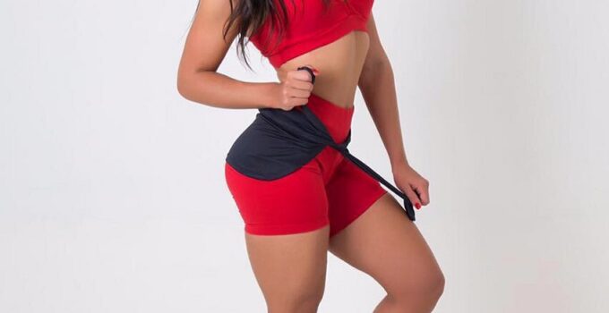 Amanda Choairy posing for a photo shoot in her red sportswear