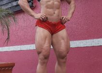 Carla Inhaia showcasing her ripped abs and legs for the photo
