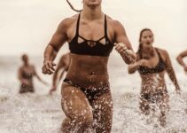 Dani Elle Speegle running in shallow water competing against other athletes