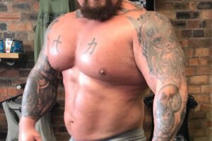 Eddie Hall posing shirtless for the photo looking strong and big