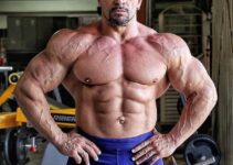 Fernando Sardinha posing shirtless in the gym, looking huge and ripped