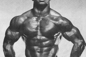 Harold Poole performing a bodybuilding pose looking big and ripped