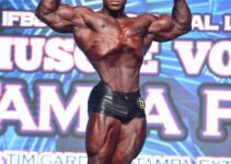 Keone Pearson doing a front double biceps pose on the classic bodybuilding stage