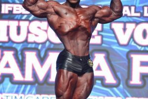 Keone Pearson doing a front double biceps pose on the classic bodybuilding stage