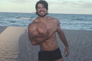 Lucas Giovani flexing on the beach looking fit and lean