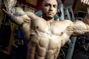 Matheus Donaire doing a shirtless front double biceps flex