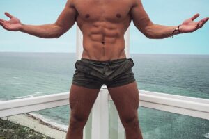 Max Wyatt posing on a balcony looking fit and lean