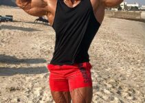 Mohamed El Qadi doing a front double biceps flex looking huge and ripped
