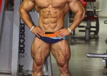 Mohammed Foda posing shirtless in the gym, looking massive and ripped