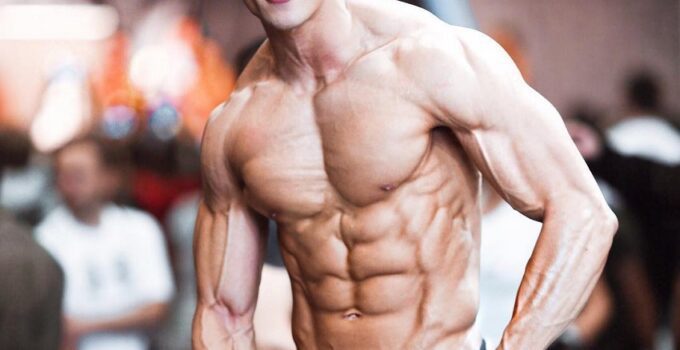 Nam Vo flexing shirtless for the photo looking ripped