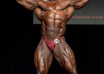 Ricardo Correia hitting a front double biceps pose on the bodybuilding stage