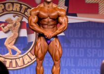 Samir Troudi flexing in his most muscular pose on the bodybuilding stage