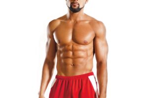 Shaun T showing off his muscles in a fitness photo shoot