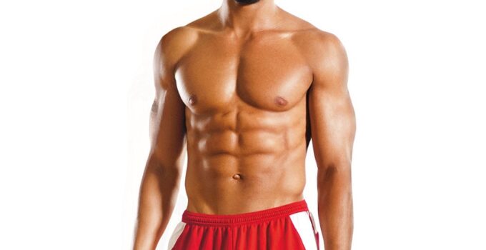 Shaun T showing off his muscles in a fitness photo shoot