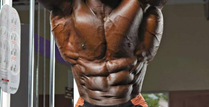 Toney Freeman flexing his abs in a professional bodybuilding photo shoot