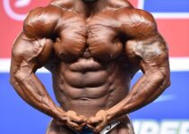 Abdelaziz Jellali flexing his muscles in a bodybuilding contest in front of an audience