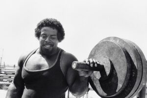 Bill Pettis in his prime, holding onto a barbell for the 1984 Olympics poster.