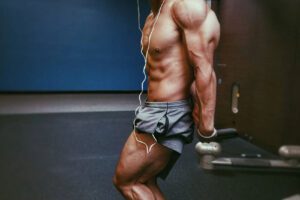 Chris Lavado posing, showing off his physique in the gym.