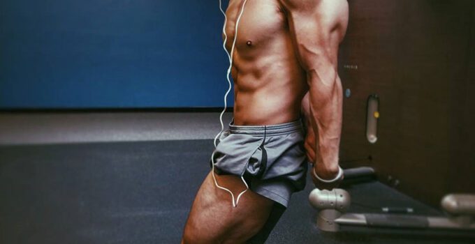 Chris Lavado posing, showing off his physique in the gym.