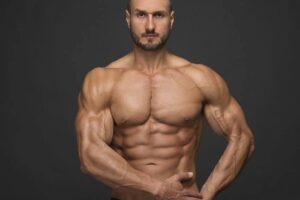 Emil Goliath posing directly in front of the camera, looking lean and aesthetic