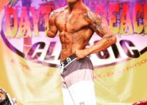 Jared Bullock on stage at a bodybuilding competition.,