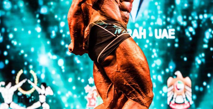 Morgan Aste flexing his muscles at a competition