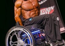 Nick Scott on stage at a bodybuilding competition.