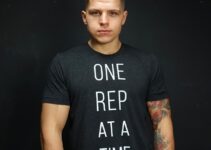 ObesetoBeast posing for a photo in a black shirt with motivational quote "One Rep at a time"