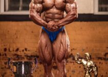 Sasan Heirati posing with his trophies, looking ripped and muscular