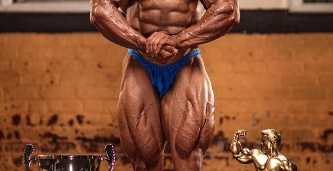 Sasan Heirati posing with his trophies, looking ripped and muscular