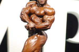 Shaun Clarida flexing on the bodybuilding stage.